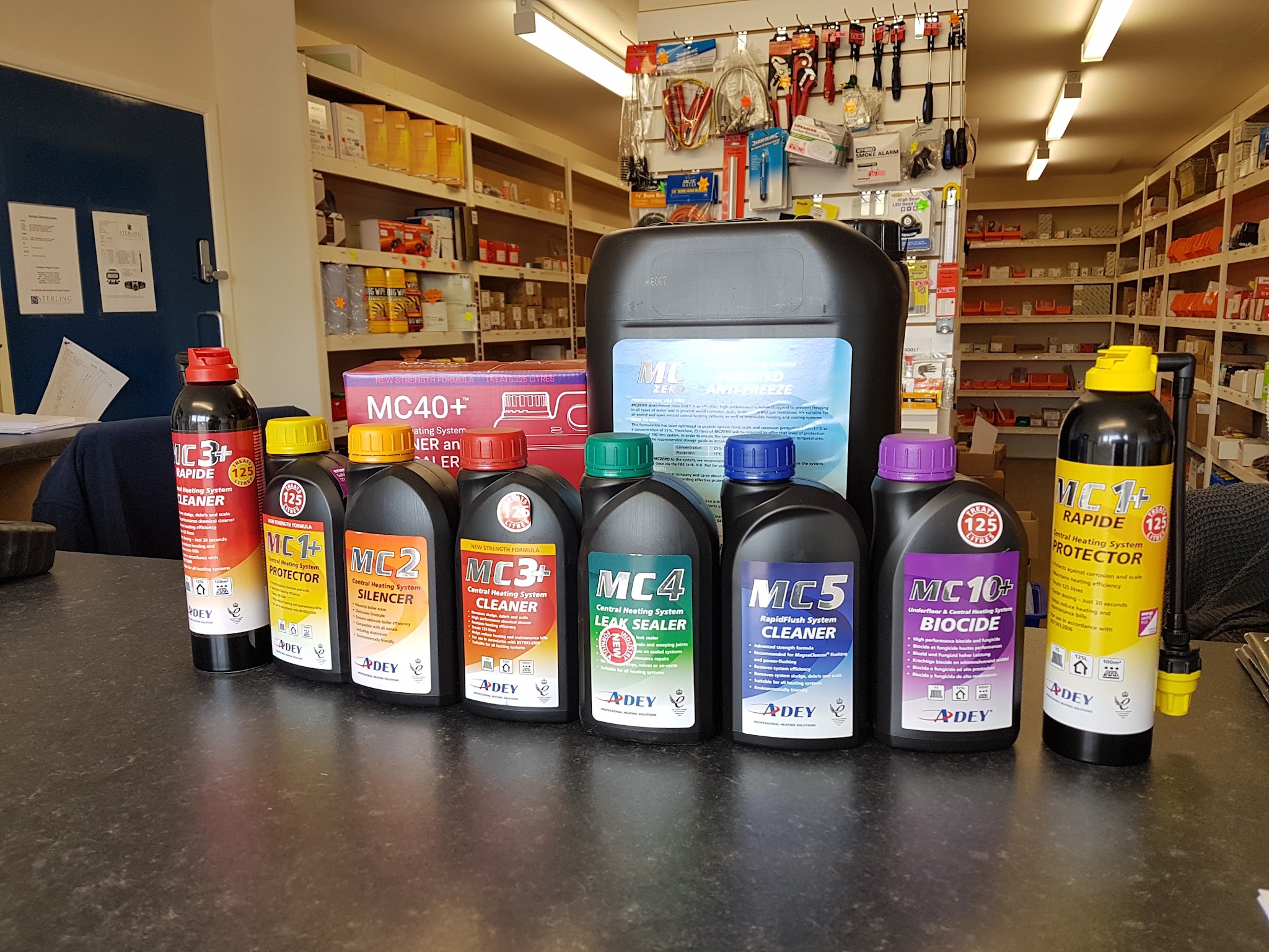 The trade counter, with Adey system chemicals on the counter and stocked parts shelves behind